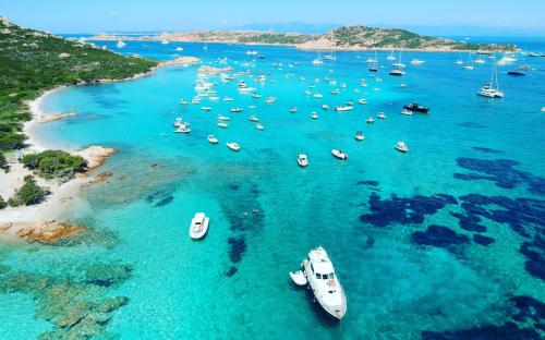 <p>Boats in the crystal clear sea by boat in the Archipelago of La Maddalena</p><p><br></p>