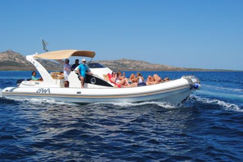 <p>Inflatable boat with tourists on board during excursion in the Gulf of Asinara</p><p><br></p>