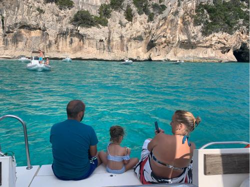 family of day trippers on a boat in the Gulf of Orosei