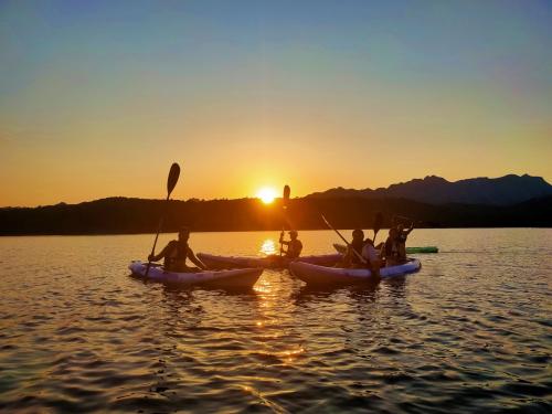 Hikers at sunset by kayak