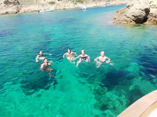 Swim in the crystal clear waters of La Maddalena during a boat tour