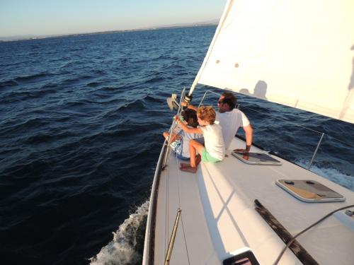 Father and son aboard a sailboat