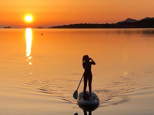 Girl in SUP in the light of dawn