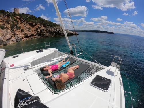 Girls sunbathe aboard a catamaran
