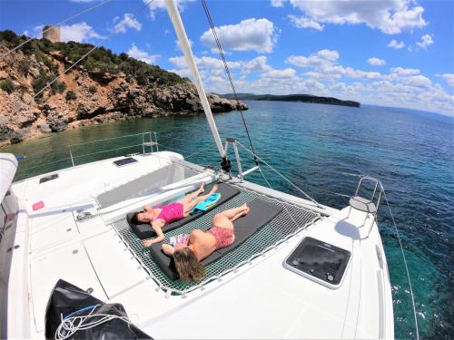 Girls sunbathing aboard a catamaran in Alghero