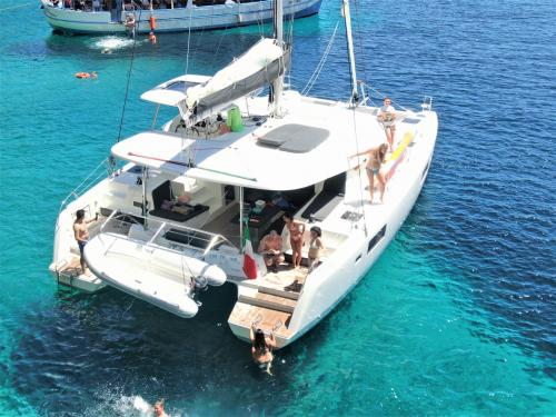 Catamaran and tourists during excursion to Alghero