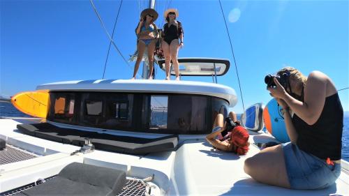 Girls sunbathing aboard a catamaran in Alghero