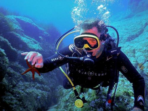 Hiker during an underwater baptism in north-eastern Sardinia