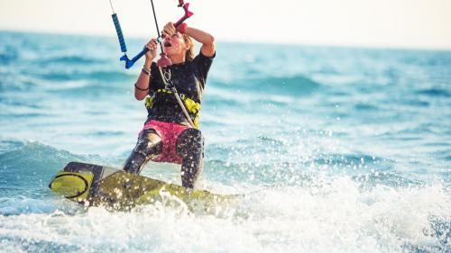 Girl during test of kitesurfing in the water