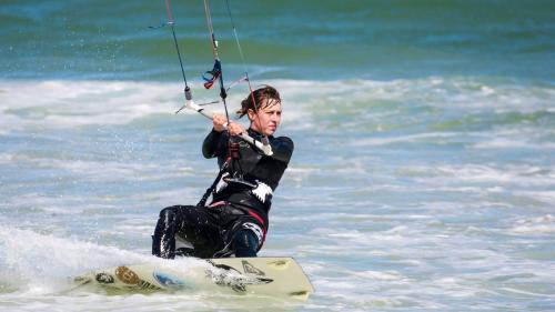 Chica durante la experiencia de kitesurf guiada