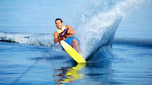 Boy practicing wakeboard with instructor