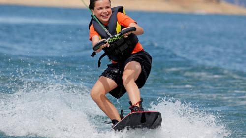 Child during wakeboarding and water skiing excursion in Vignola Mare