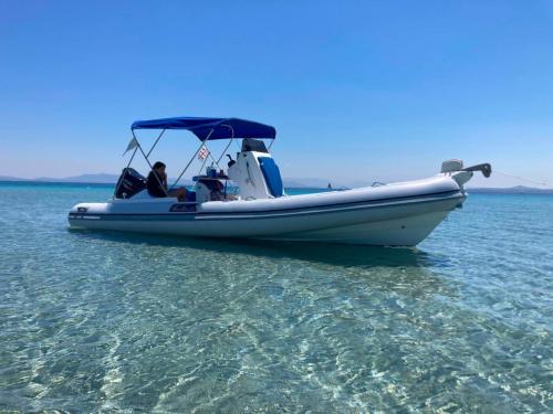 Gommone spazioso con tendalino nel mare blu di San Pietro e Masua