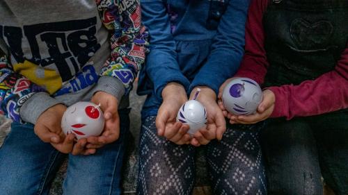 Children create their own candle during wax workshop in Mamoiada