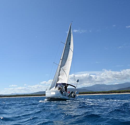 Sailing boat sails in the Gulf of Orosei during daily excursion