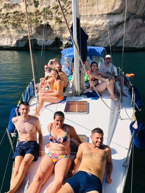 Hikers aboard a sailing boat in the Gulf of Cagliari