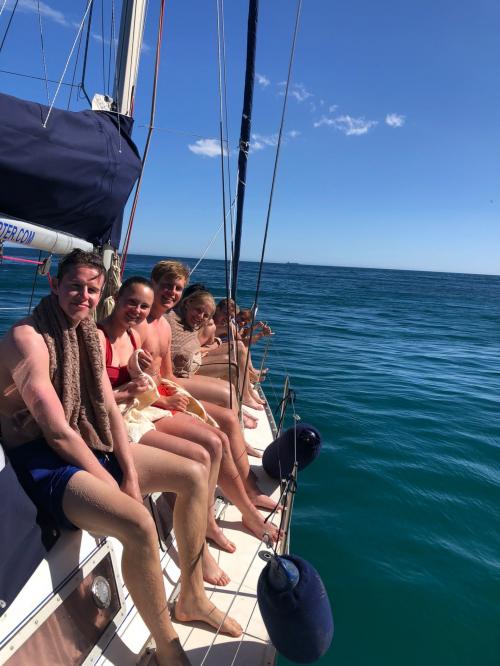 Hikers aboard a sailing boat in the Gulf of Cagliari