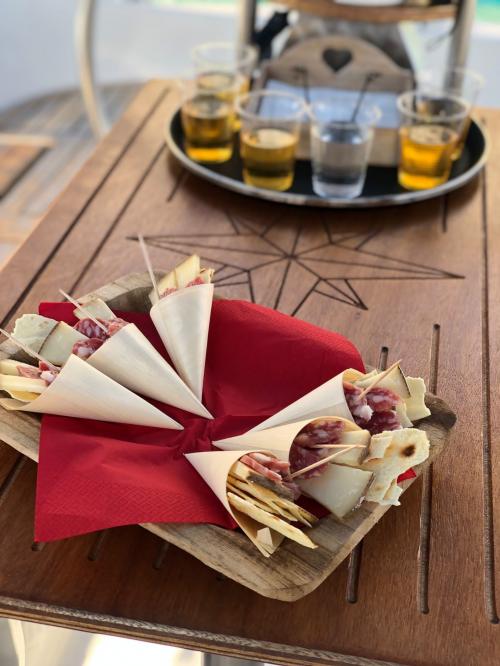Aperitif with typical Sardinian products served on board a sailing boat in the Gulf of Cagliari