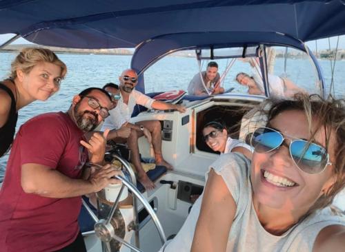 Hikers aboard a sailing boat in the Gulf of Cagliari