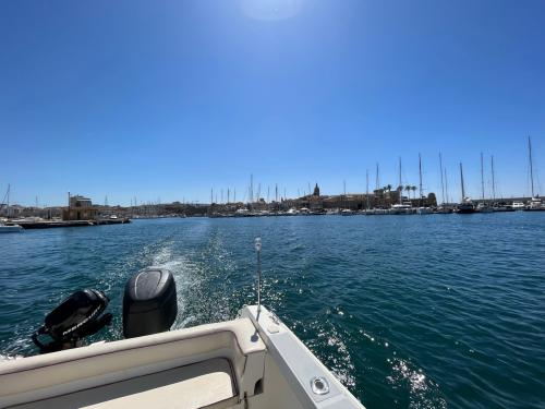 Exit from Alghero harbor by boat during tour