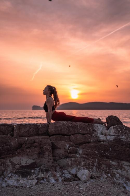 <p>Yoga teacher at sunset in Alghero with Capo Caccia in the background</p><p><br></p>