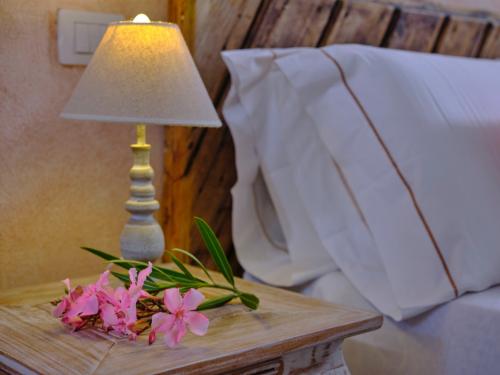 <p>Detail of a lamp and bedside table in a tourist accommodation in the territory of Olbia</p>