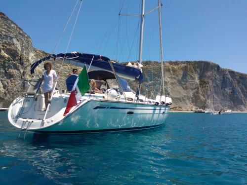 Sailing boat with people on board during the excursion to Tavolara