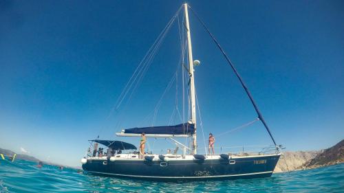 Spacious sailing boat sails in the crystal clear waters of the Protected Marine Area of Tavolara