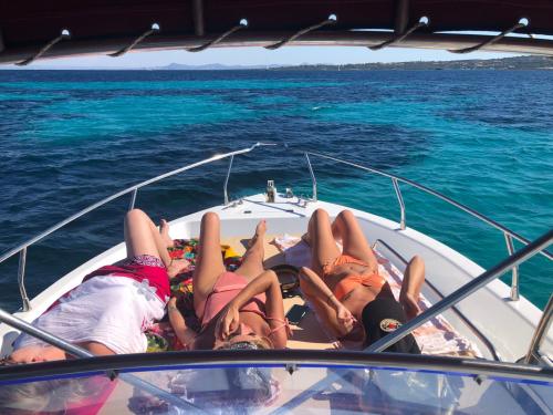 Hikers during a relaxing moment on board a boat in the Gulf of Asinara