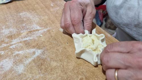 Closing ricottelle during a traditional cooking workshop near Bosa