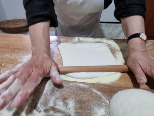 Sardinian woman rolls out the pasta dough