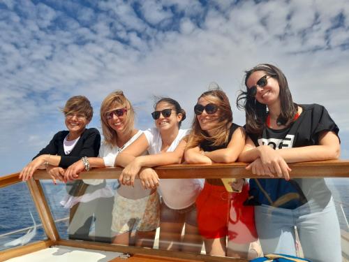 Girls aboard a wooden gozzo in the Asinara Gulf