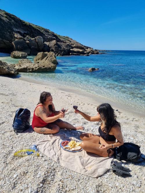 <p>Hikers have a drink on the beach during guided tours</p><p><br></p>