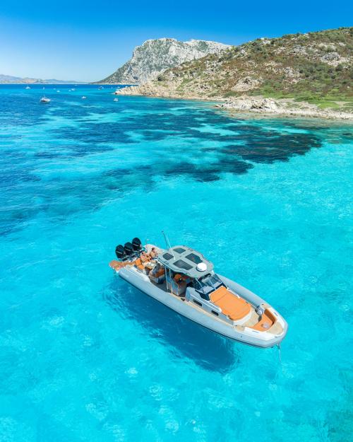 <p>Boat in the crystal clear sea of the Protected Marine Area of Tavolara</p><p><br></p>