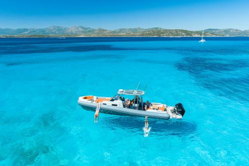 <p>Boat in the crystal clear sea of the Protected Marine Area of Tavolara</p><p><br></p>