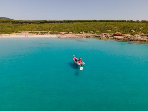 Rubber dinghy in the beaches of the coast of Alghero