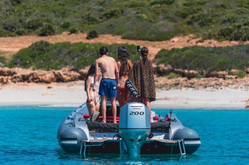 Boys aboard an inflatable boat during tour in the Gulf of Alghero