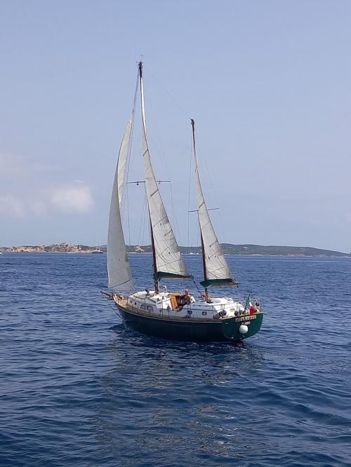 Sailboat with sails unfurled sailing in the La Maddalena Archipelago