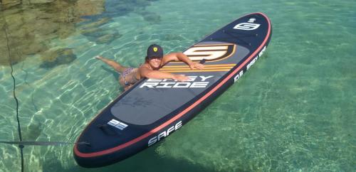 Girl on SUP in the crystal clear sea of Palau