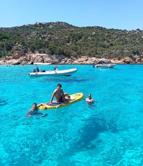 Friends on SUP in the clear sea of la Maddalena Archipelago