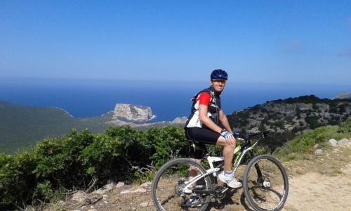 Cyclist on the Alghero coast Capo Caccia Porto Conte Pineta Mugoni le Bombarde
