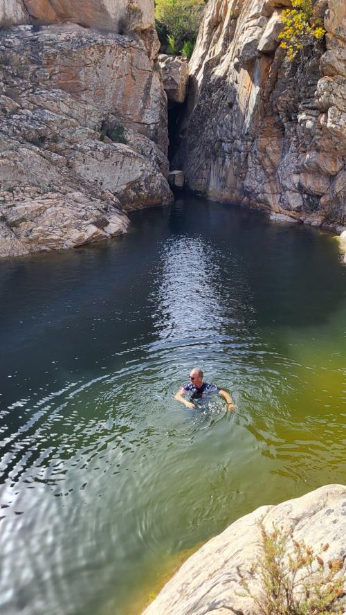 hikers in the natural pools of riu pitrisconi in San Teodoro