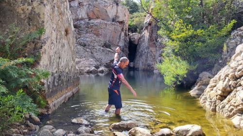 hikers in the natural pools of riu pitrisconi in San Teodoro