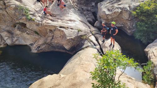 hikers in the natural pools of riu pitrisconi in San Teodoro