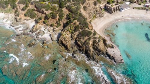 <p>Masua beach top view with turquoise sea and rocks</p><p><br></p>