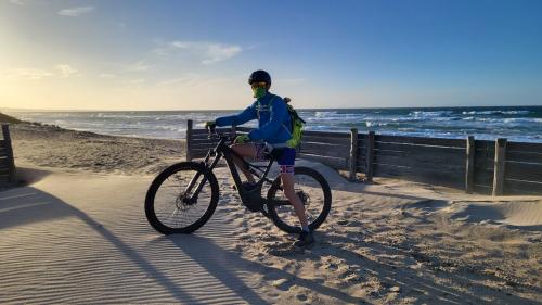 boy on electric bike on the beach