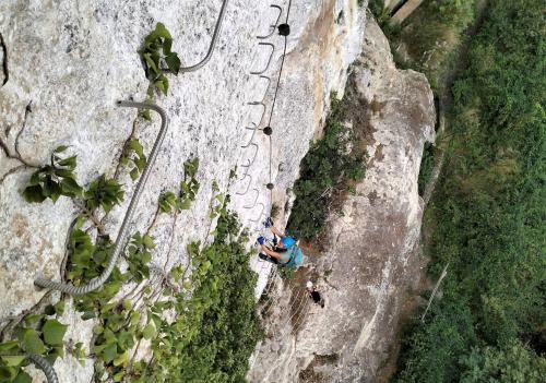Photo from the top of a hiker in the via ferrata of Rocca Doria