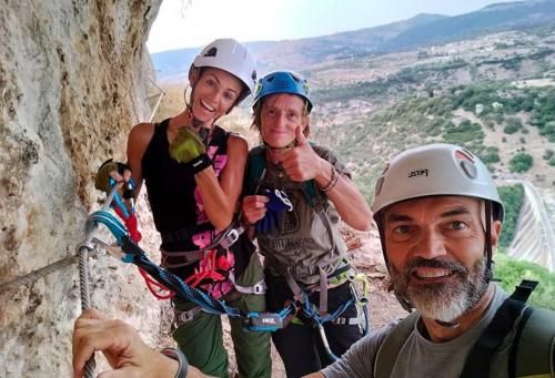 Guide with two hikers in a viewpoint of the via ferrata of Rocca Doria