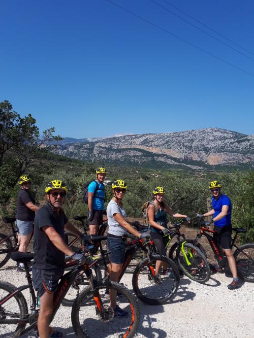 hikers on electric bikes in the Sardinian inland mountains between Dorgali Orosei Baunei on the east coast of the island