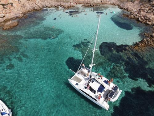 Catamaran in the crystal clear waters of the Archipelago of La Maddalena